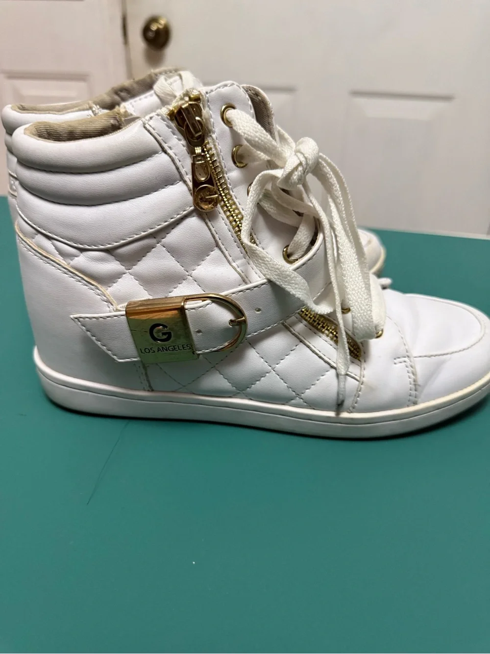 GUESS High-Top Wedge Sneakers in white faux leather.